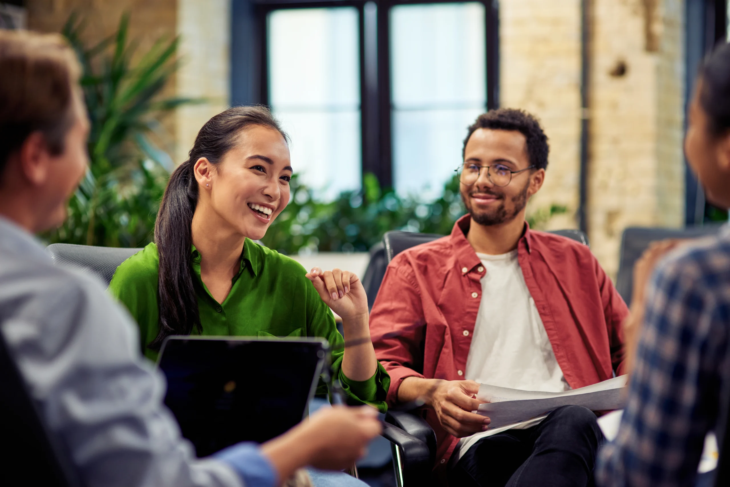 Young cheerful asian business woman discussing project results with colleagues while working together in the modern office Young cheerful asian business woman discussing project results with colleagues while working together in the modern office. Teamwork and cooperation concept