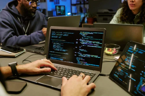 Young Adult Men and Man Collaborating on Software Development Project